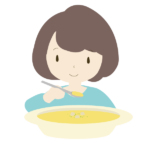 コーンポータージュスープを飲む女性