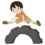 タイヤの跳び箱を飛ぶ少年