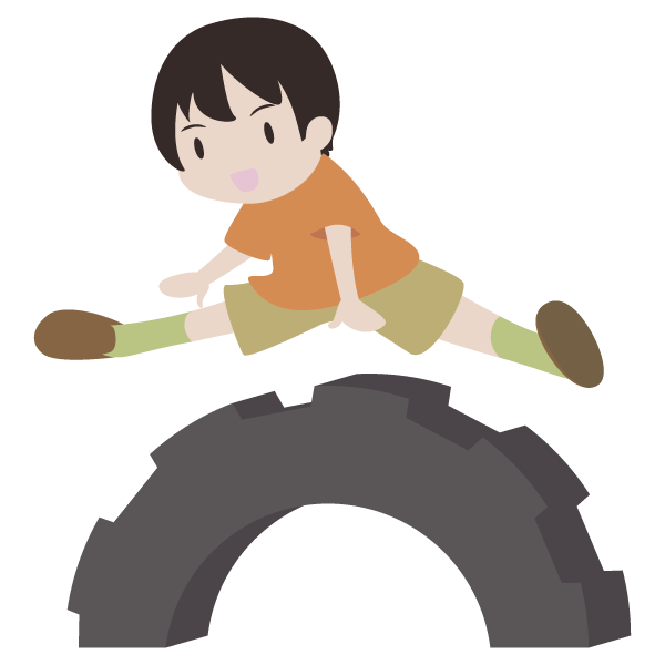 タイヤの跳び箱を飛ぶ少年