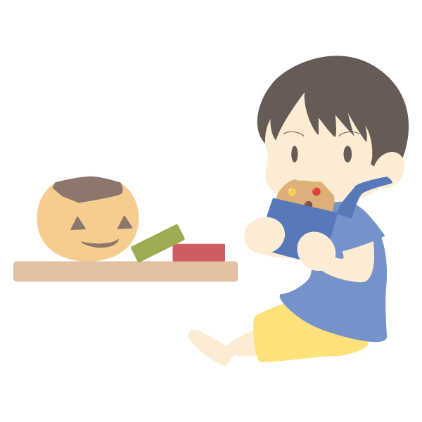 ハロウィンでもらったお菓子を食べる少年