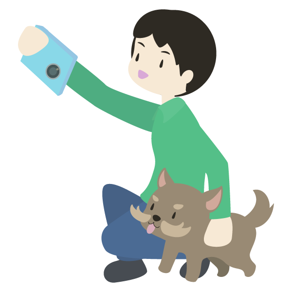 スマートフォンで愛犬と写真を撮影する飼い主